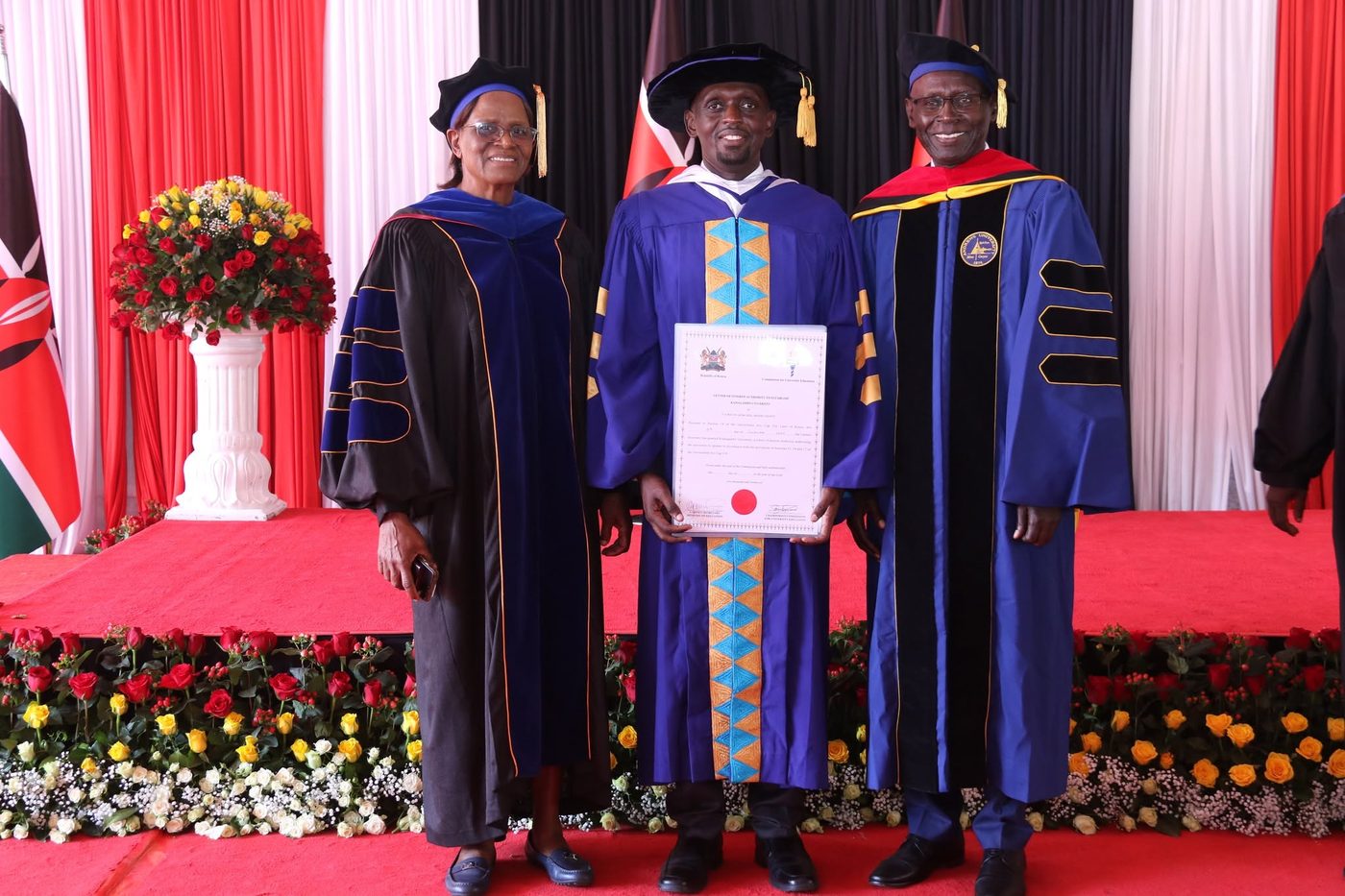 Prof. Rei Towet Kesis, Vice Chancellor of Kamagambo University, holding his certification document